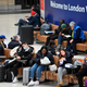 Travelers wear protective face masks as they wait on the concourse at London Victoria train station in central London on March 3, 2020.